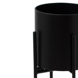 matt black cylindrical planter on black frame