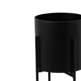 large matt black cylindrical planter on black frame