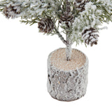 small snowy fir tree with pinecones in wood log