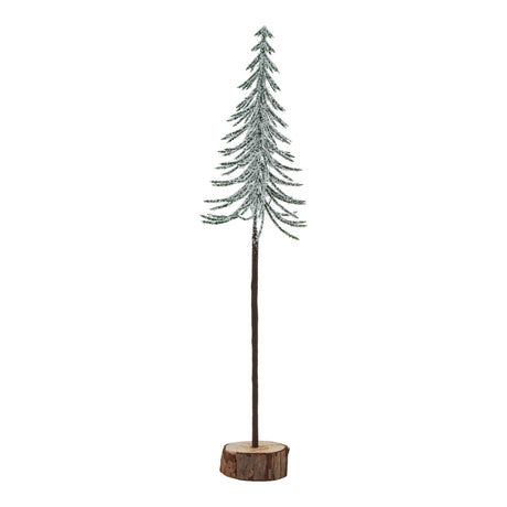 large snowy spindle tree in wood log