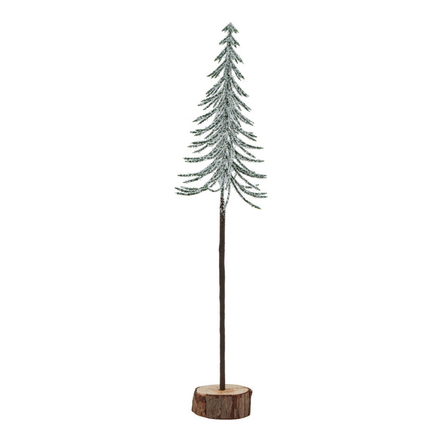large snowy spindle tree in wood log